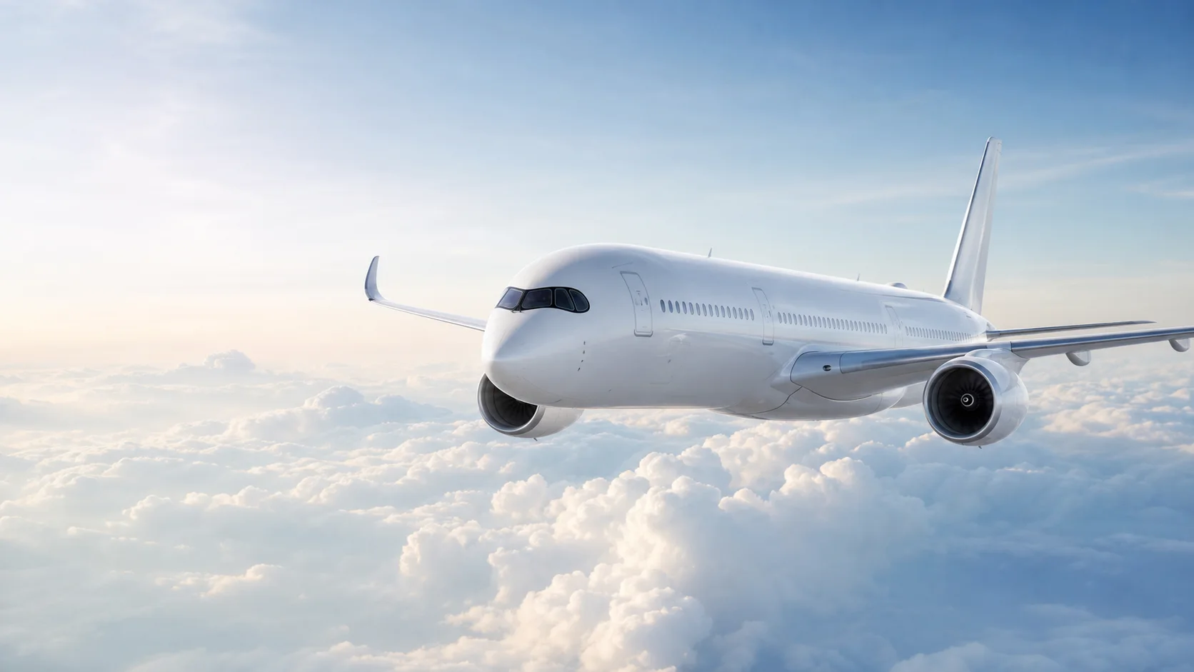 Airbus A350-1000 widebody aircraft flying over clouds in bright morning light