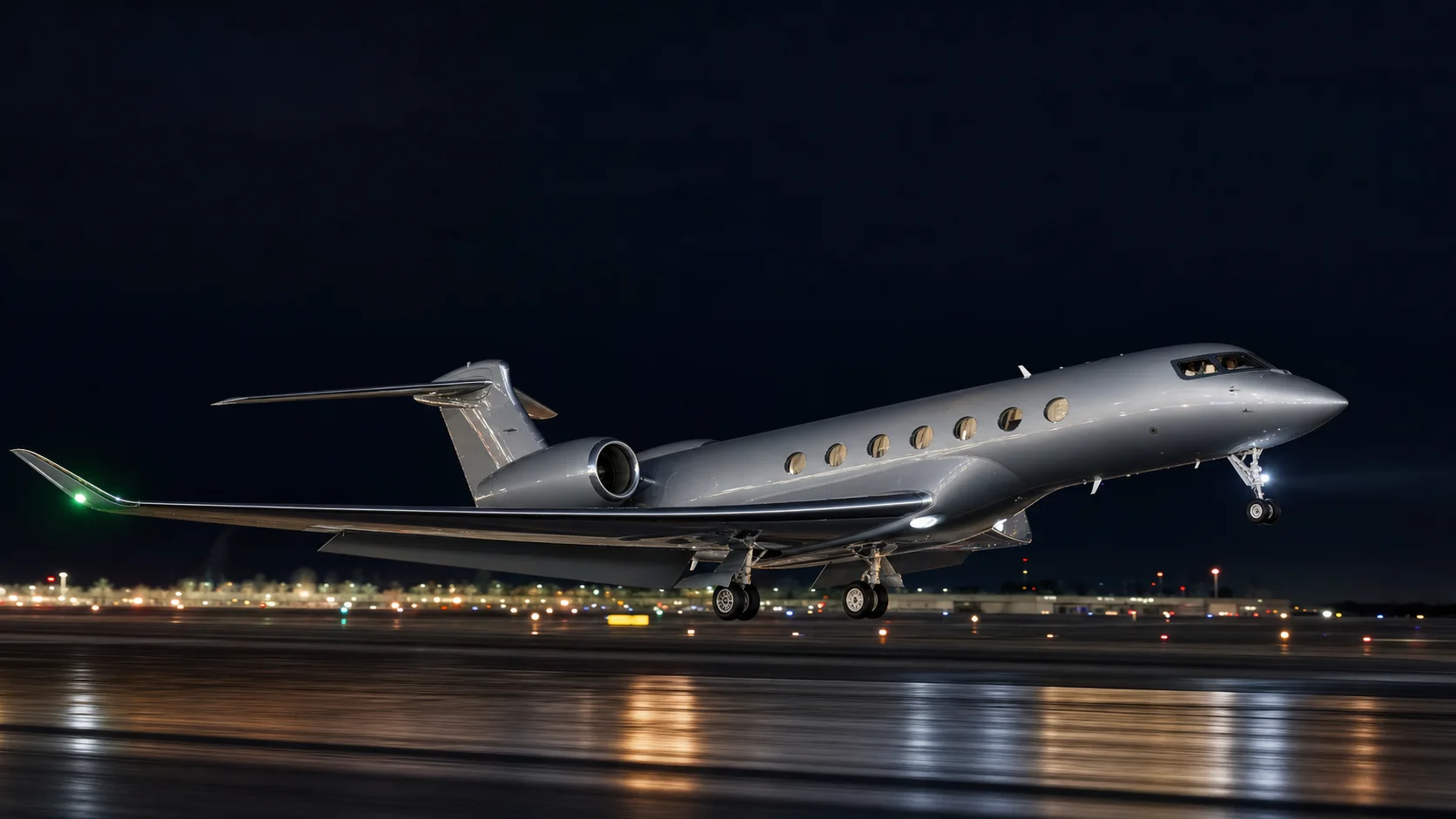 Gulfstream G700 business jet on a runway at night